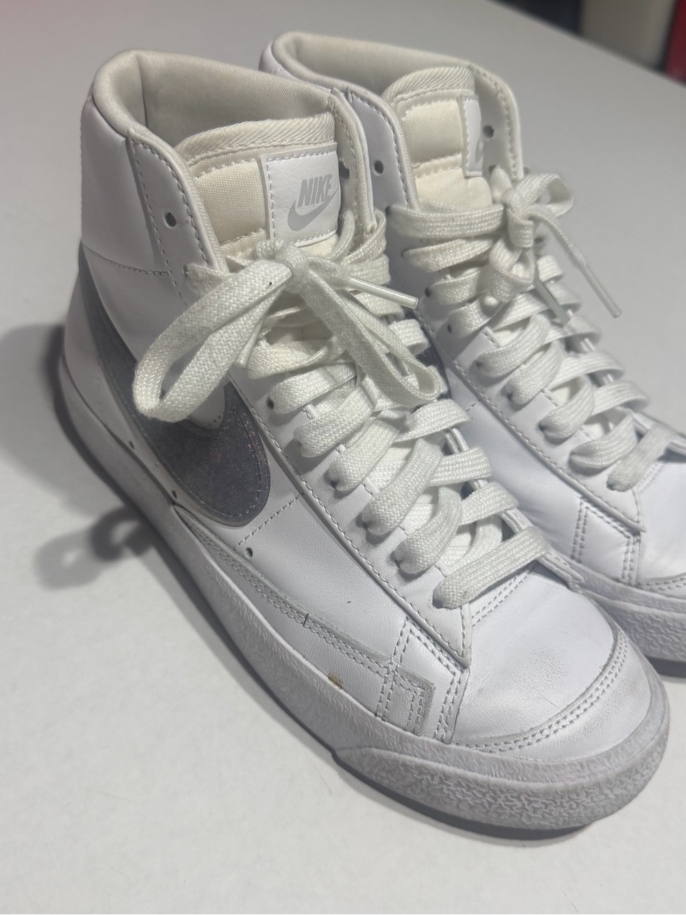 Nike White High-Top Sneakers with Silver Swoosh Accent